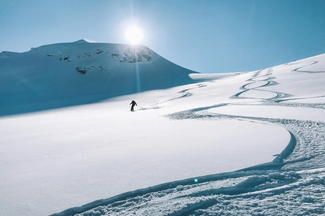 A skier’s tracks across fresh snow in New Zealand’s mountains