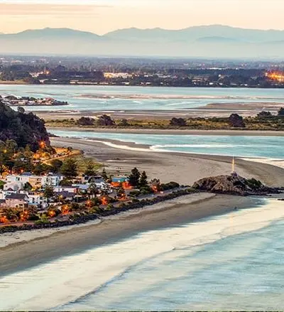 Beachside township and tidal estuary on the coast of New Zealand