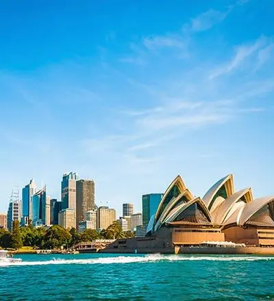 Sydney Opera House and harbour under a bright blue sky