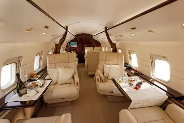 Bombardier Challenger 604 cabin with club seating and a table