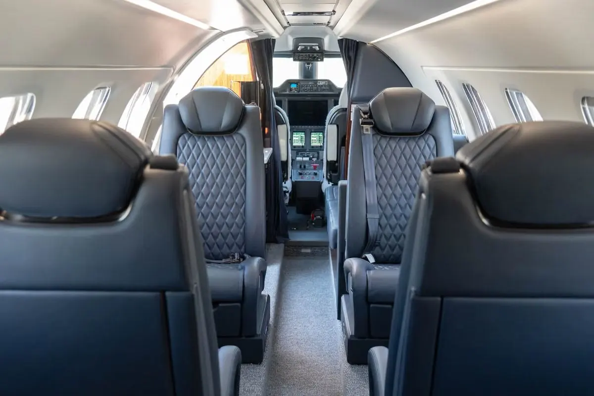 Embraer Phenom 300E cabin with dark leather seats