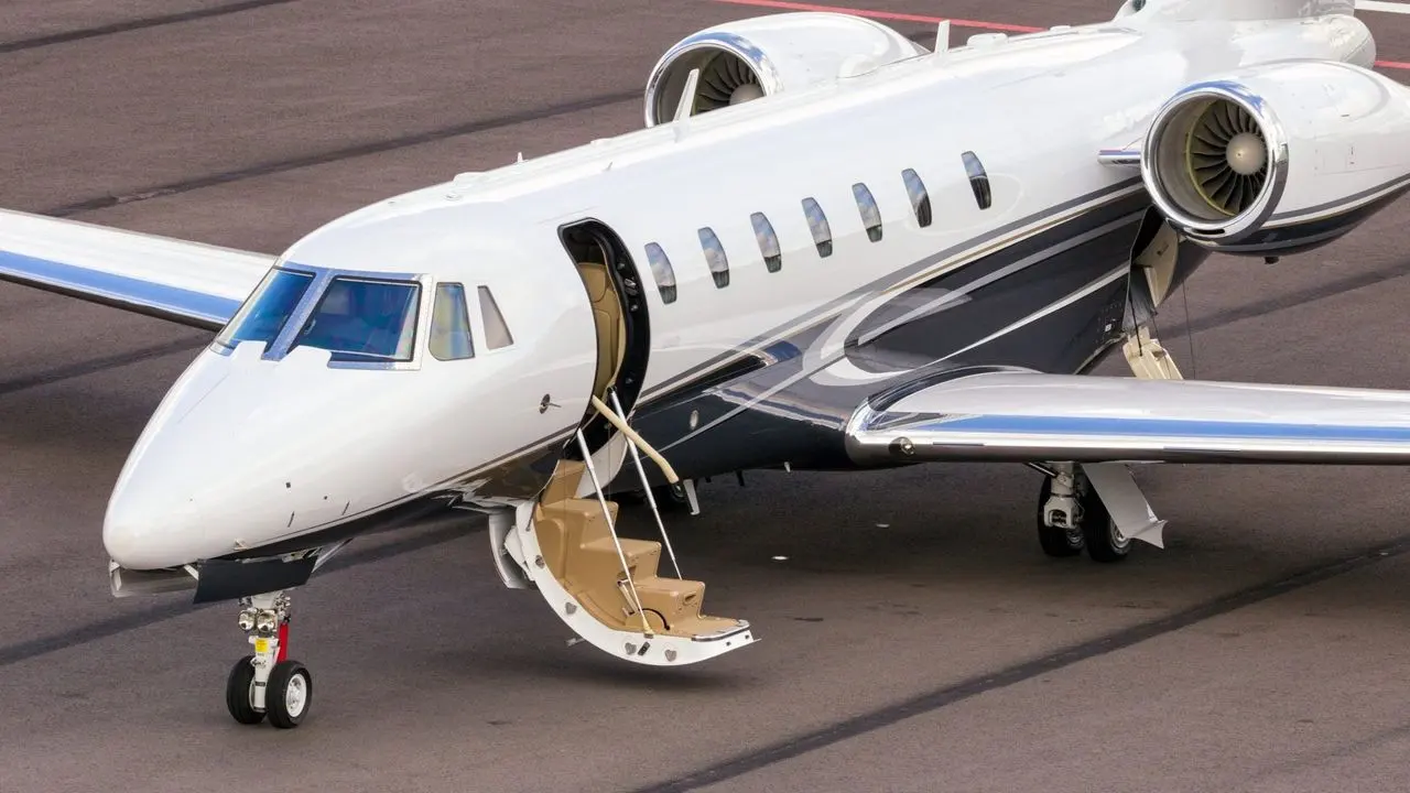 Private jet with its cabin door open and the steps down