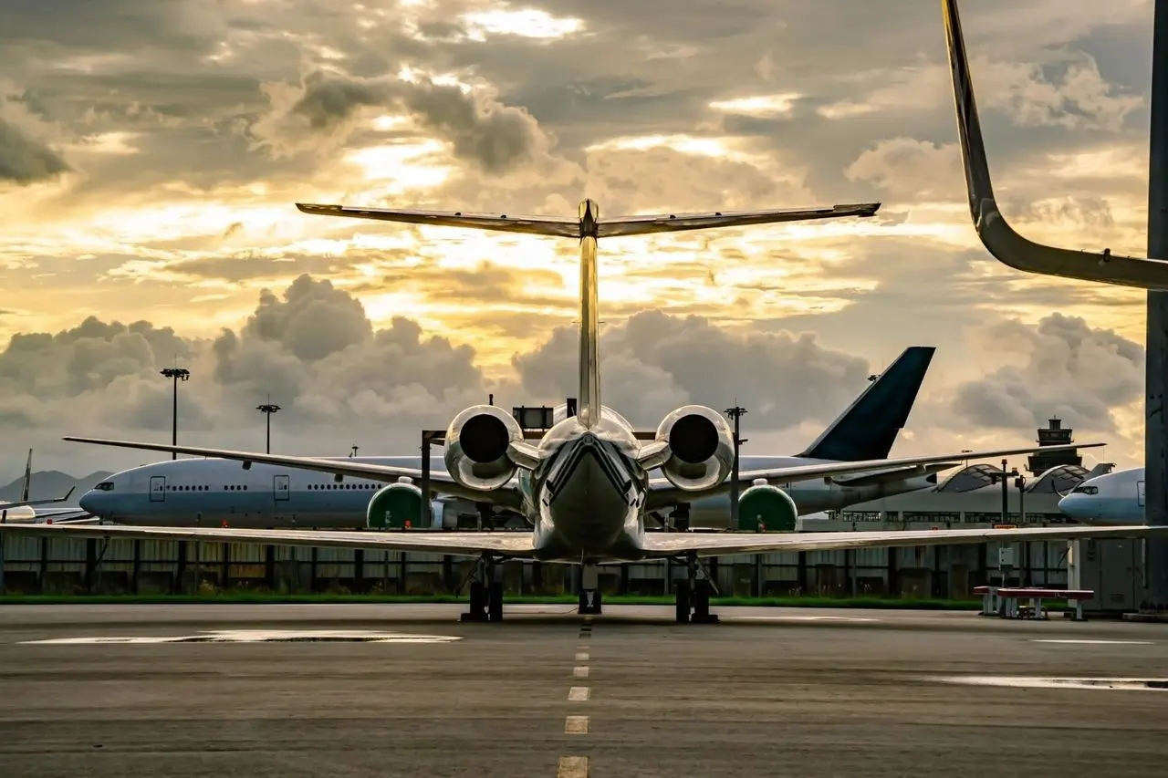 Private jet facing the camera on the apron at sunset