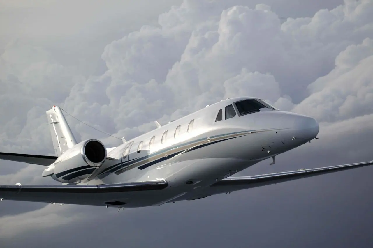 Private jet in flight above the clouds