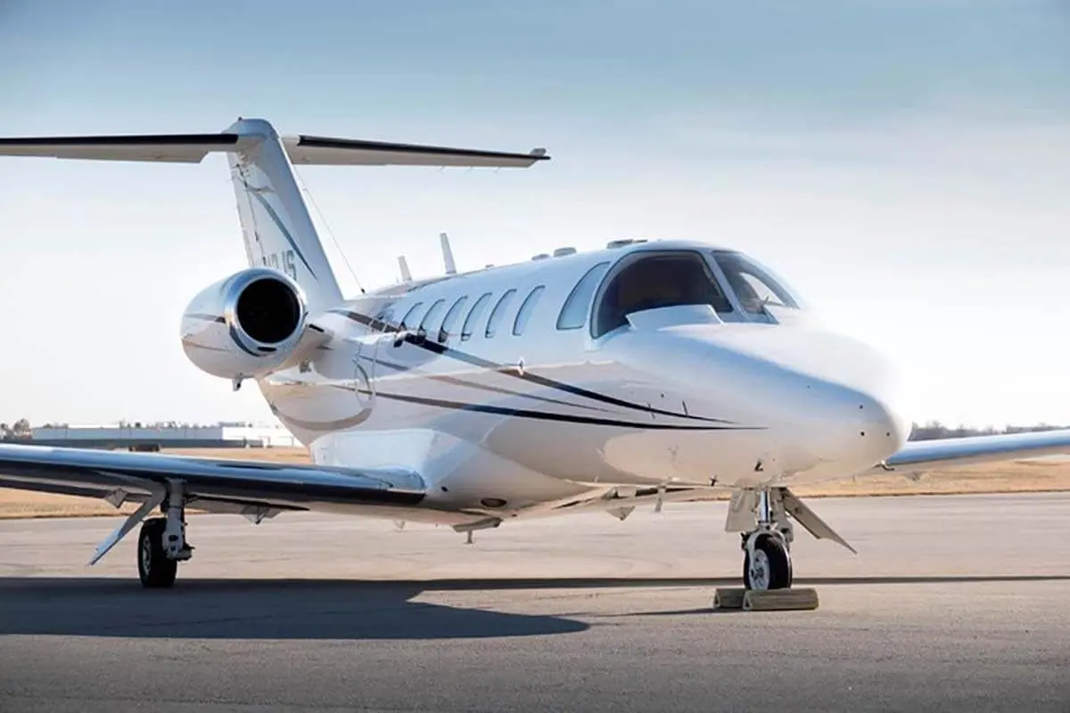 Light private jet parked on the apron