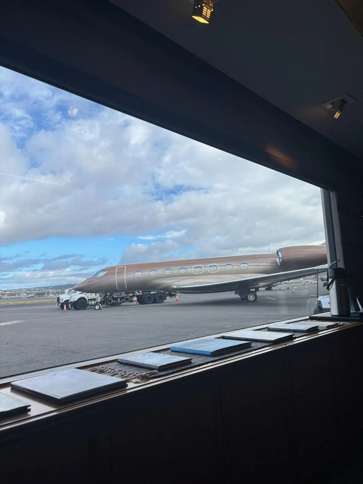 View of the apron and parked aircraft from an open private jet doorway