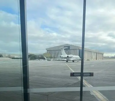 Private jet parked outside a hangar on the apron at Melbourne Airport