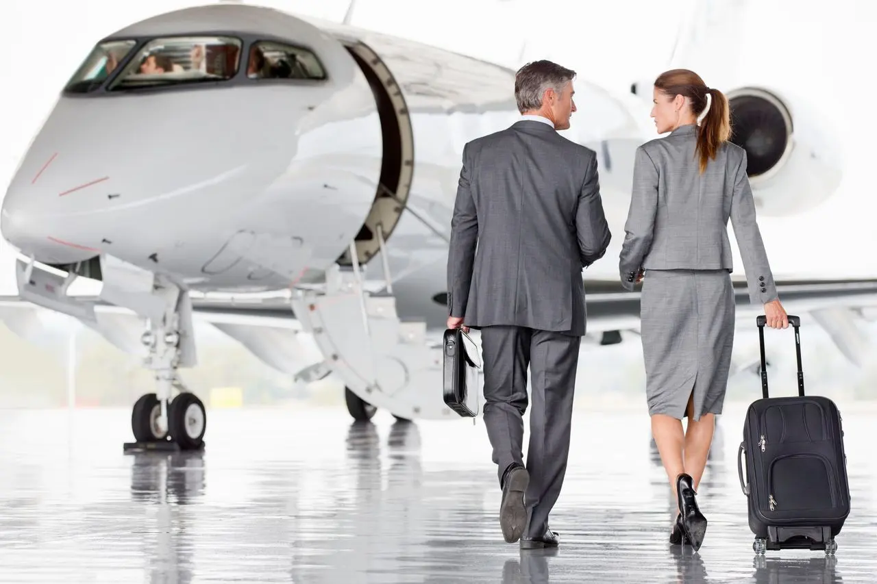 Two passengers walking out to a private jet
