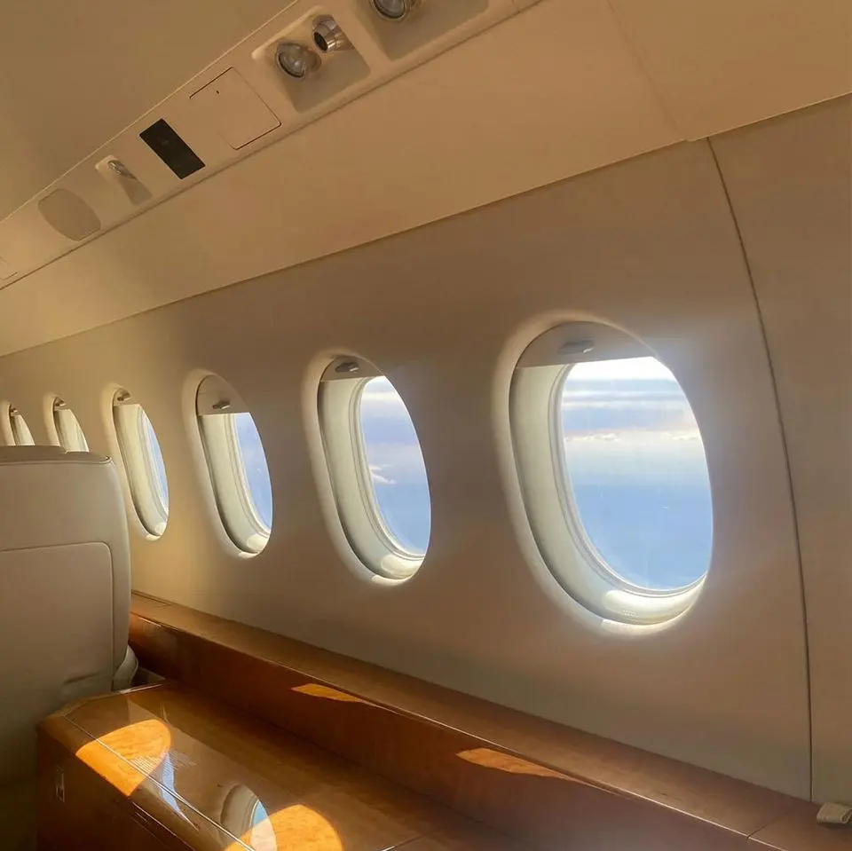 Luxury private jet cabin interior with a row of windows