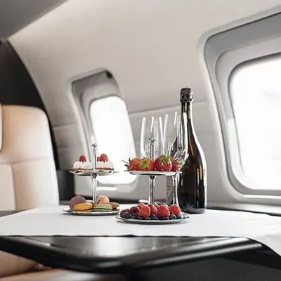 In-flight refreshments of champagne, fruit and pastries on a private jet