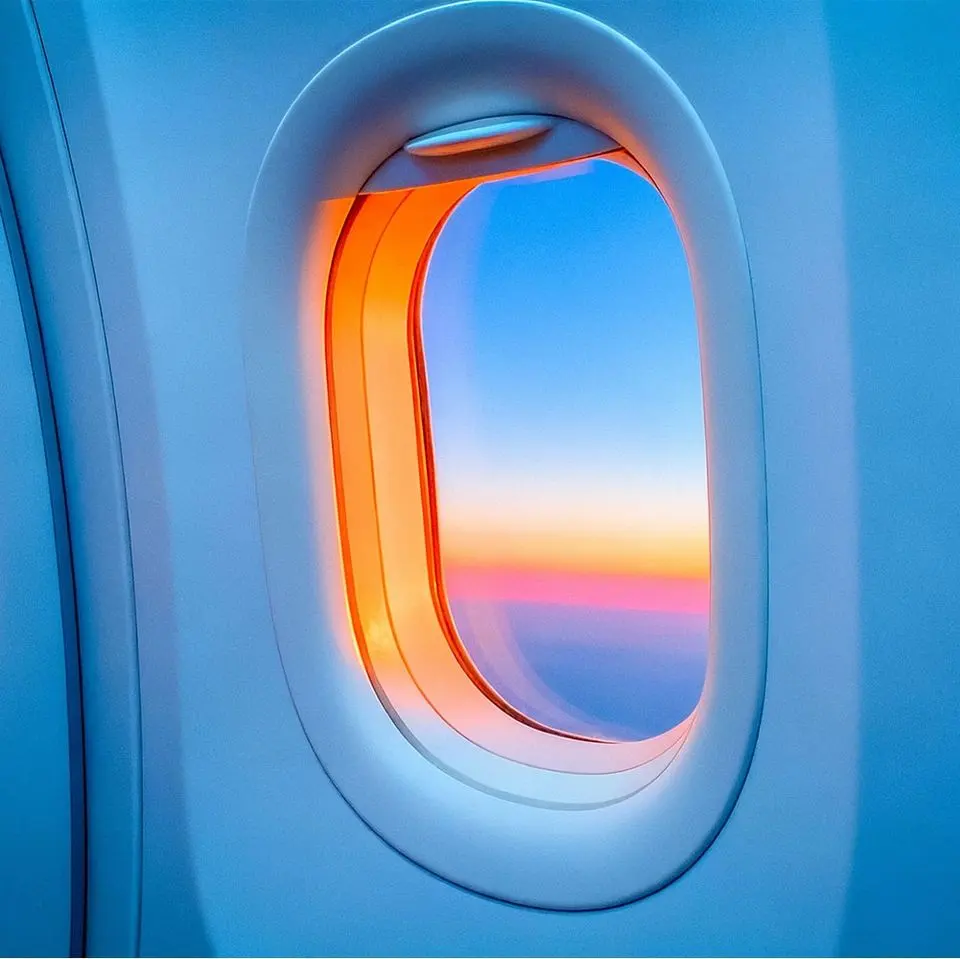 Colourful sunset sky seen through a private jet cabin window